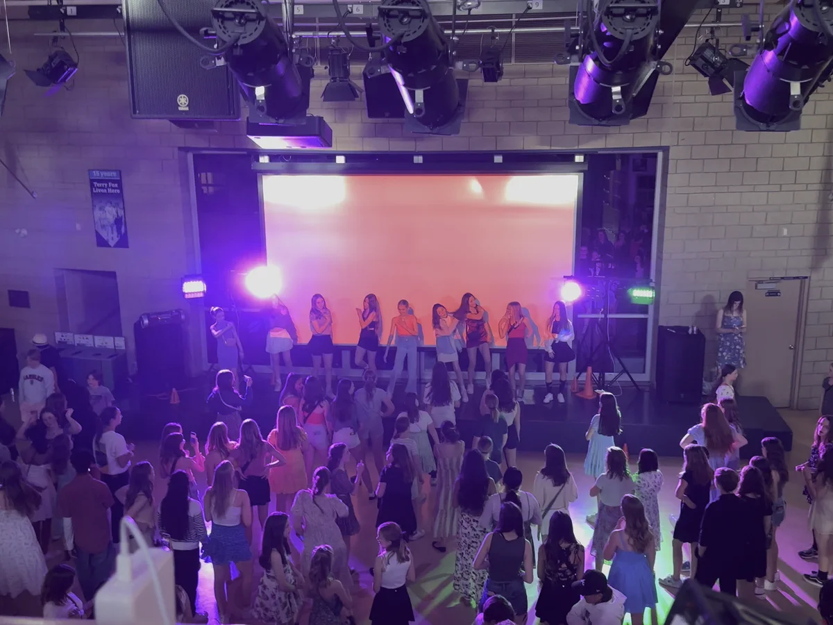 School dance crowd with stage lighting