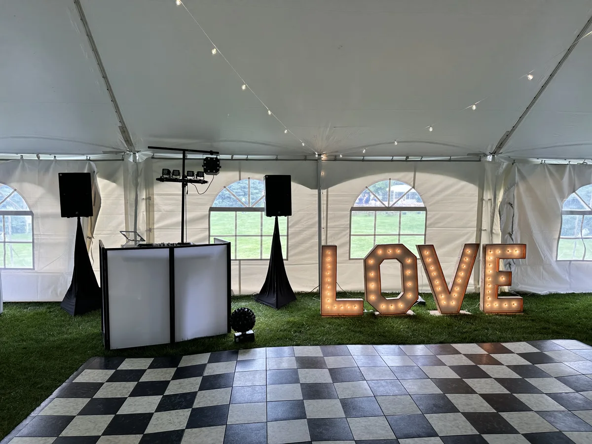 Wedding DJ setup with dance floor and LOVE sign