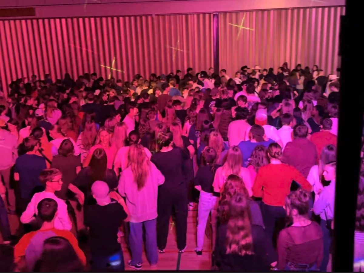 Crowded youth dance with colorful lighting